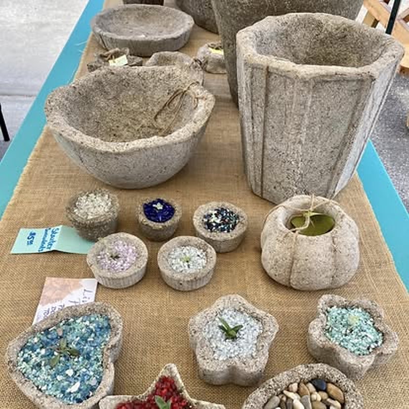Hypertufa planters and glass-filled candleholders on burlap